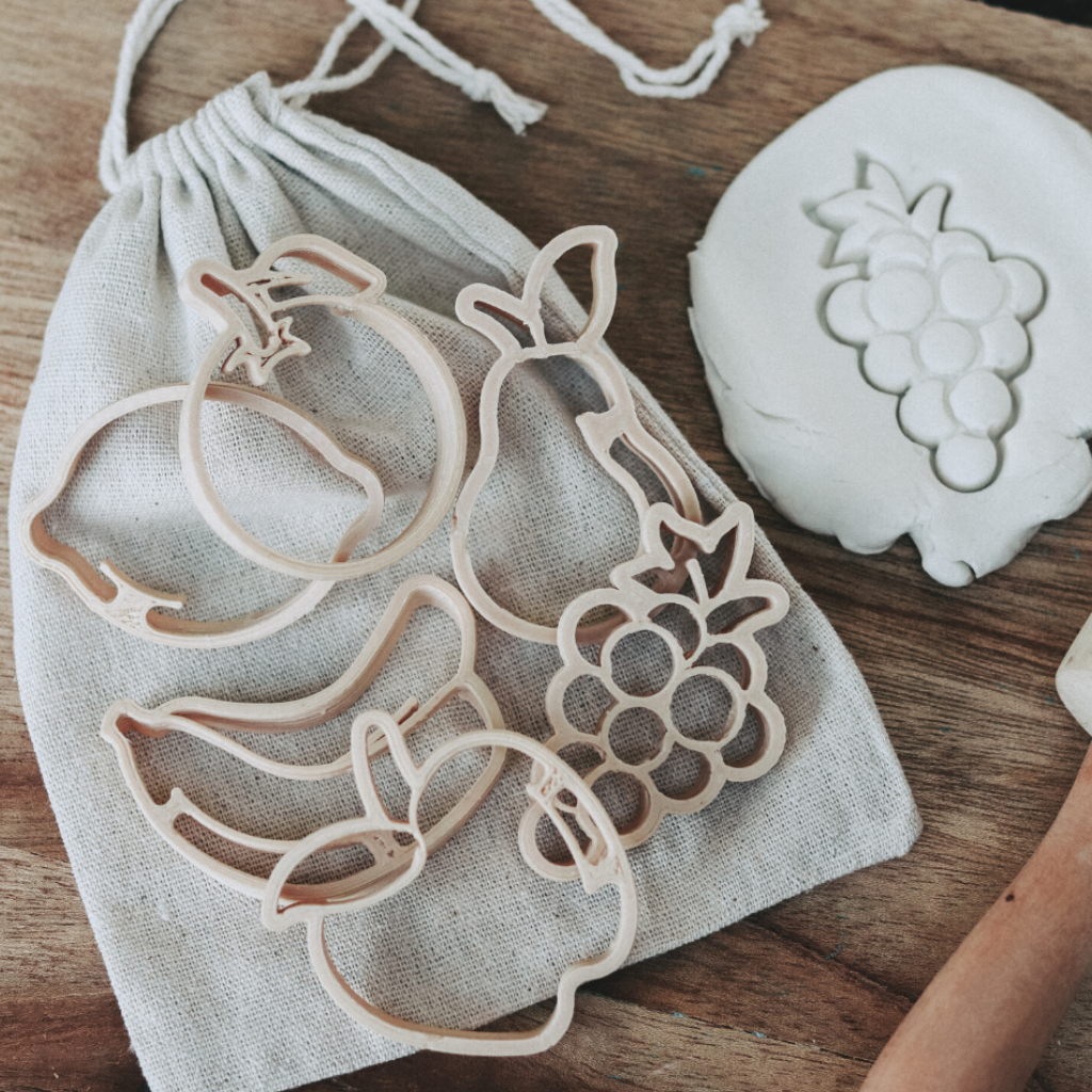 Young child using the mini Fruit Eco Cutter set to discover the oceans and marine life. Australian made, all natural Eco Cutters which are biodegradable. Help them learn with nature toys from Kinfolk Pantry.